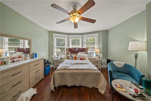 bedroom with dark wood finished floors, ceiling fan, and baseboards