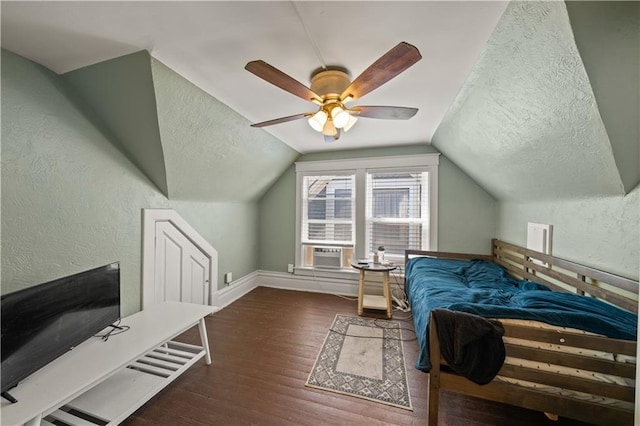 bedroom featuring a textured wall, a textured ceiling, lofted ceiling, and wood finished floors