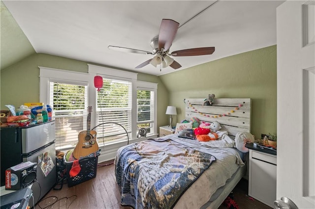 bedroom featuring hardwood / wood-style floors, lofted ceiling, and ceiling fan