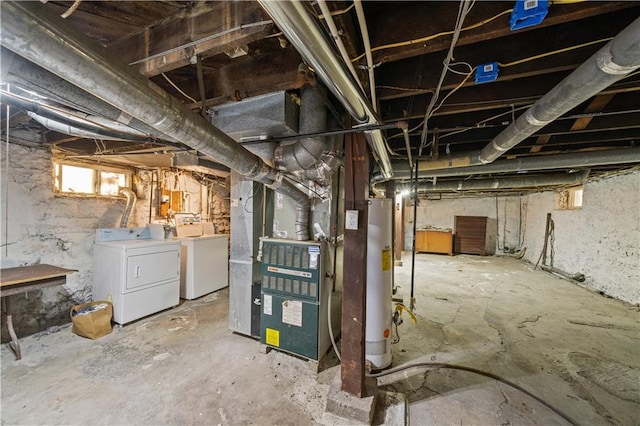 basement with gas water heater, heating unit, and washing machine and clothes dryer