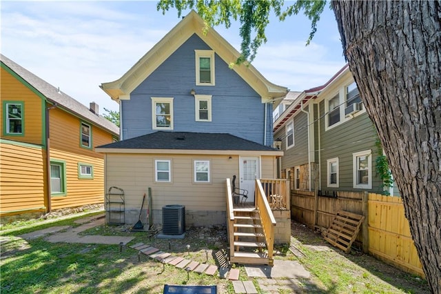 back of house featuring cooling unit and fence