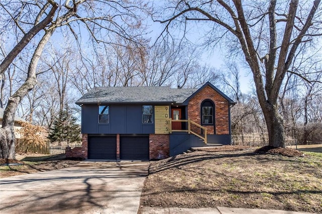 view of front of home featuring board and batten siding, concrete driveway, an attached garage, and brick siding