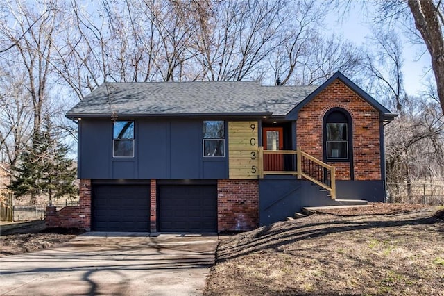 view of front of property with brick siding, fence, concrete driveway, roof with shingles, and a garage