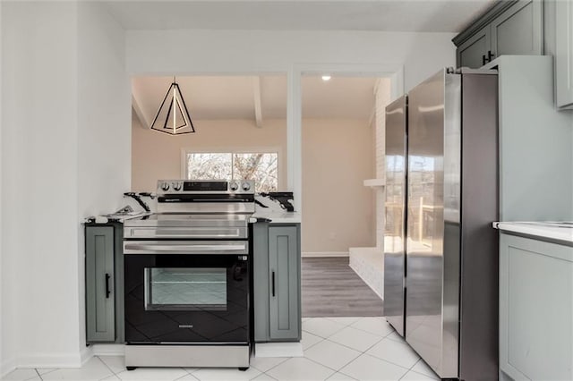 kitchen with light tile patterned floors, appliances with stainless steel finishes, gray cabinetry, and light countertops