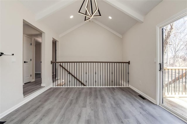 unfurnished room with wood finished floors, visible vents, baseboards, vaulted ceiling with beams, and recessed lighting