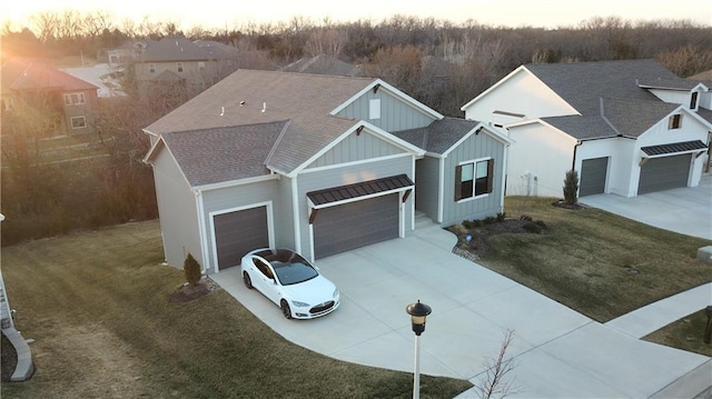 view of front of house featuring a garage, board and batten siding, driveway, and roof with shingles