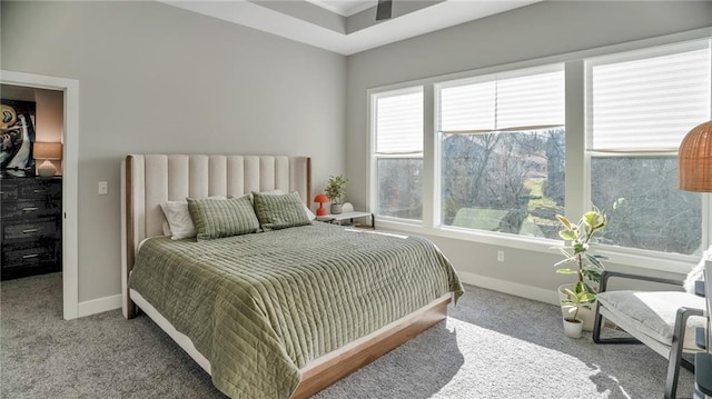 carpeted bedroom featuring baseboards