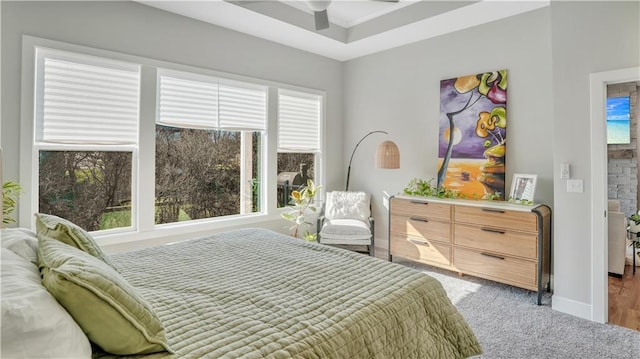 bedroom with carpet flooring, multiple windows, a ceiling fan, and baseboards