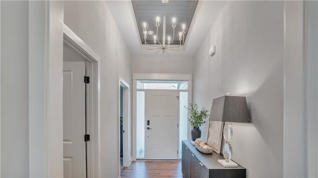 entrance foyer featuring wood finished floors and a chandelier