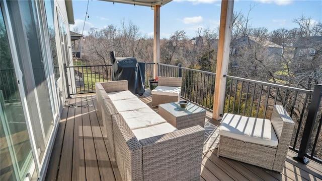 wooden deck with a grill