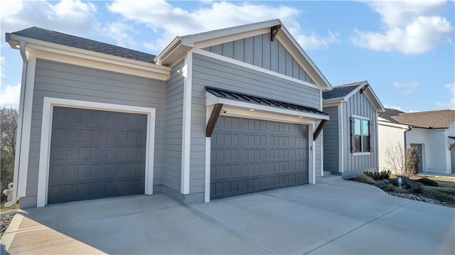 view of home's exterior featuring board and batten siding, concrete driveway, and a garage