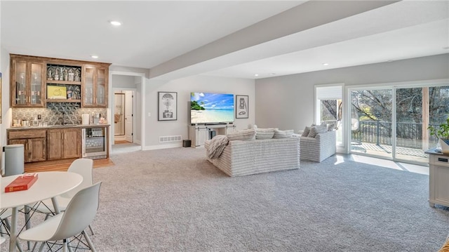 living area with light carpet, bar area, recessed lighting, wine cooler, and baseboards