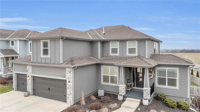 view of front of property featuring fence, roof with shingles, covered porch, driveway, and an attached garage