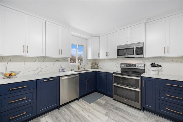 1008 Bristol Way, Liberty, MO 64068 - kitchen featuring blue cabinetry, appliances with stainless steel finishes, white cabinets, and a sink