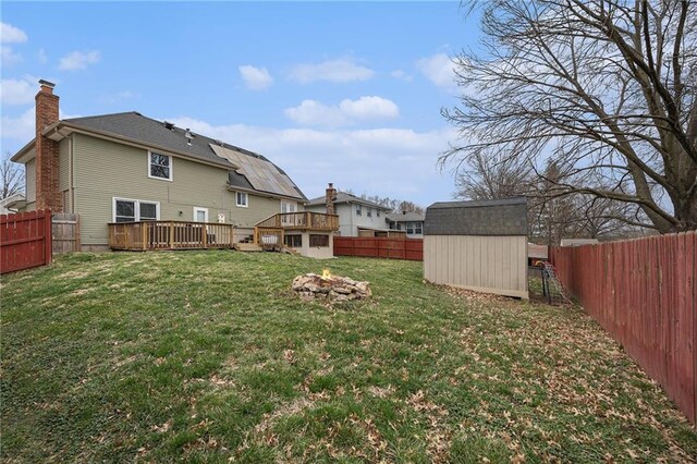 1008 Bristol Way, Liberty, MO 64068 - view of yard with a storage unit, a wooden deck, an outdoor structure, and a fenced backyard