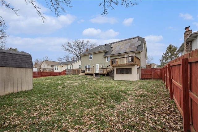 1008 Bristol Way, Liberty, MO 64068 - back of property featuring a shed, a wooden deck, a yard, a fenced backyard, and an outbuilding
