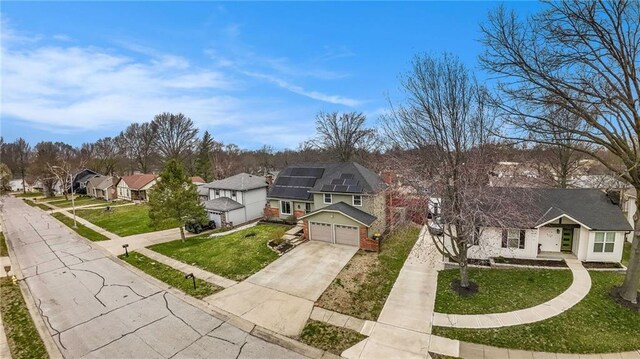1008 Bristol Way, Liberty, MO 64068 - view of front of home featuring a residential view, an attached garage, concrete driveway, and a front lawn