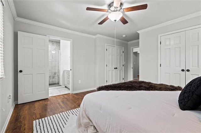 bedroom with crown molding, wood finished floors, multiple closets, and baseboards