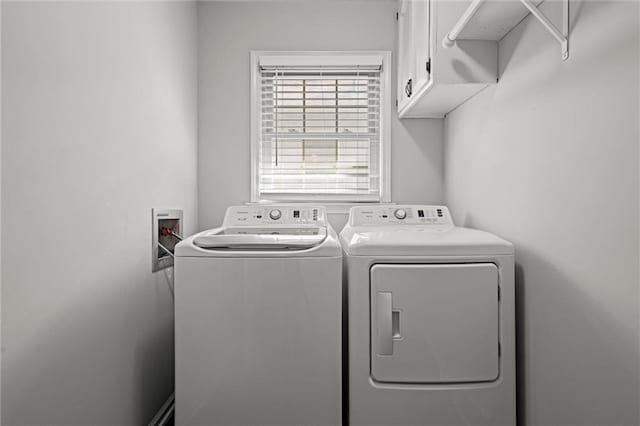 washroom with cabinet space and separate washer and dryer