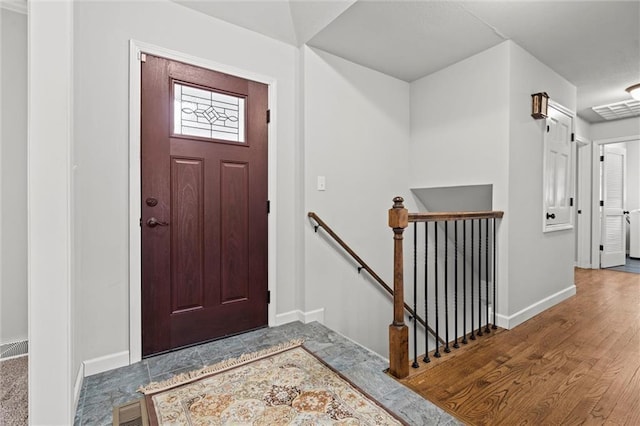 entrance foyer with visible vents, baseboards, and wood finished floors