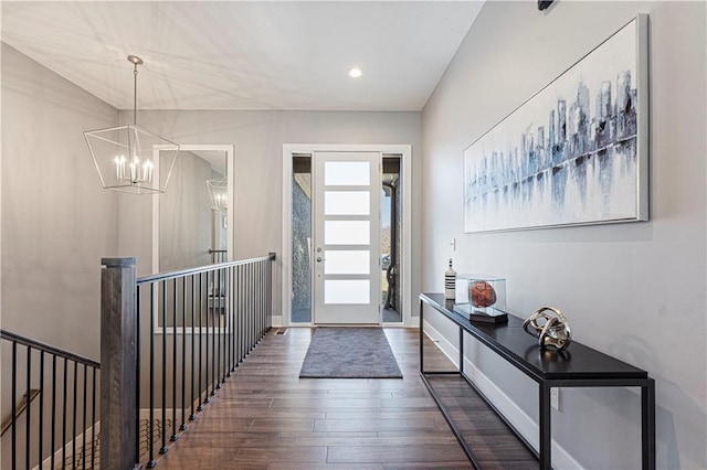 foyer featuring a notable chandelier, recessed lighting, baseboards, and wood finished floors