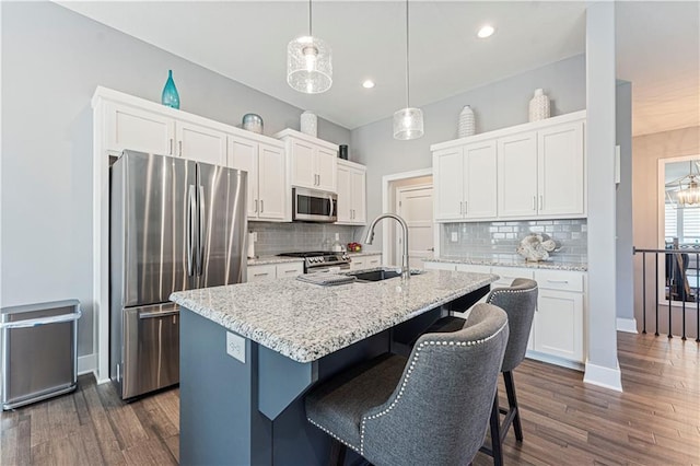 kitchen featuring a sink, dark wood-style floors, appliances with stainless steel finishes, and white cabinets