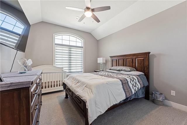 bedroom with dark carpet, baseboards, lofted ceiling, and ceiling fan