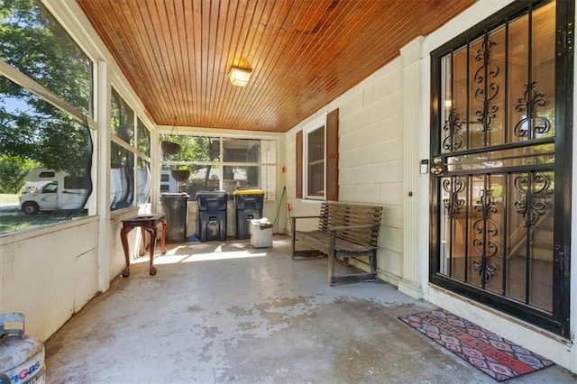 unfurnished sunroom featuring wood ceiling