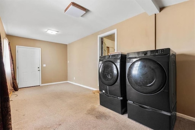 laundry area with baseboards, carpet floors, separate washer and dryer, and laundry area