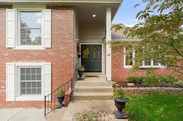 doorway to property featuring brick siding