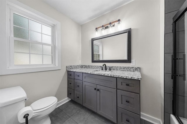 bathroom with tile patterned floors, toilet, vanity, and baseboards