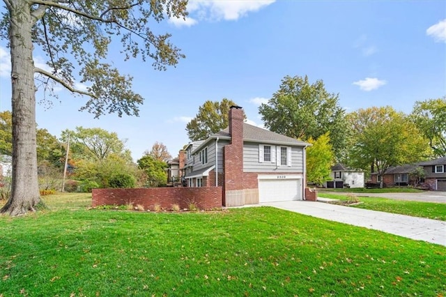 view of property exterior featuring brick siding, a chimney, a yard, a garage, and driveway