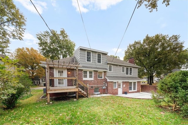 back of property with brick siding, a lawn, a pergola, and a patio