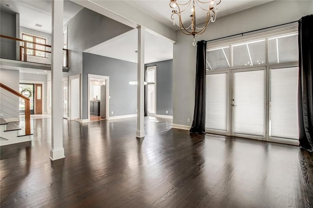 4837 W 121st St, Overland Park, KS 66209 - unfurnished room with wood finished floors, stairs, a towering ceiling, and a chandelier