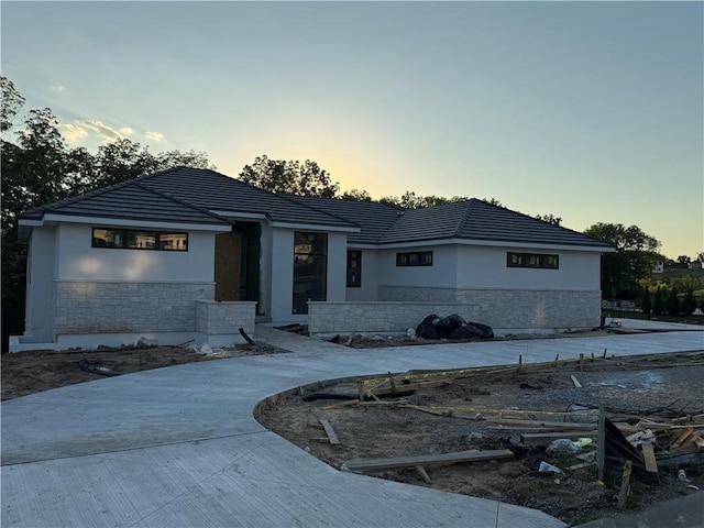 7410 NW Pampas Ln, Parkville, MO 64152 - view of front of house with stone siding and stucco siding
