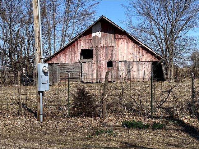 view of barn with fence