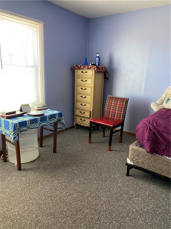 bedroom with carpet flooring and baseboards