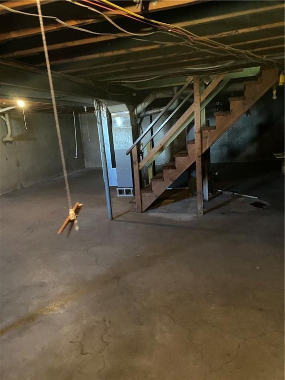 unfinished basement featuring stairway