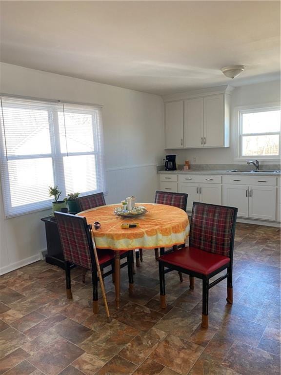 dining space with stone finish flooring