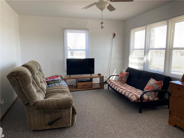 living area featuring carpet flooring and ceiling fan