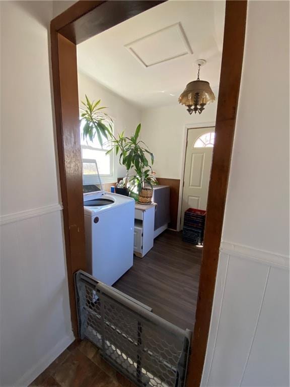 interior space with a wainscoted wall, attic access, laundry area, washer / clothes dryer, and dark wood-style flooring