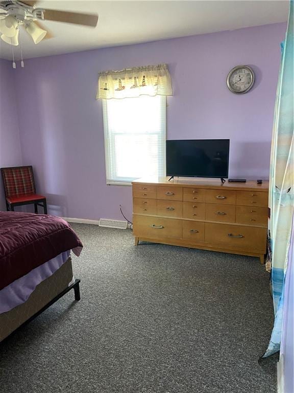 bedroom featuring baseboards and ceiling fan