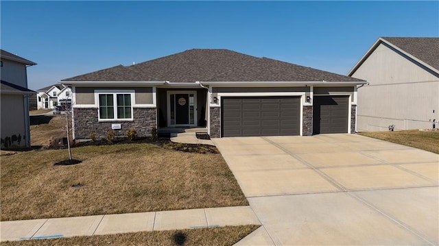 view of front facade featuring a garage, concrete driveway, a front lawn, and stone siding