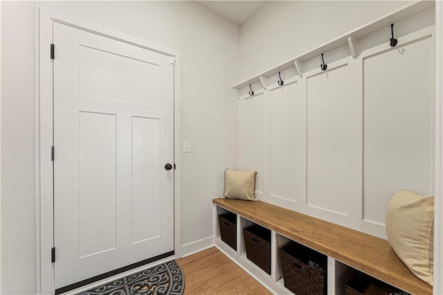 mudroom with light wood-style floors and baseboards