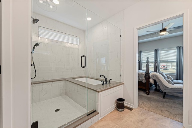 ensuite bathroom featuring a marble finish shower, connected bathroom, a ceiling fan, and baseboards