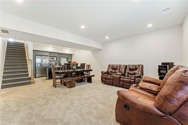 living room with recessed lighting, stairway, light colored carpet, and visible vents