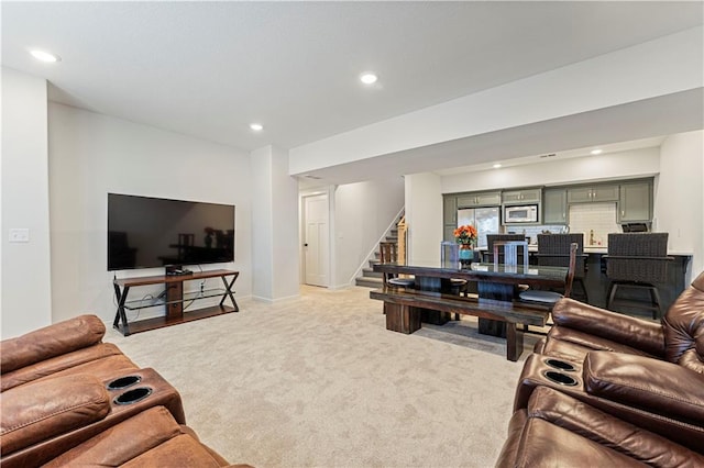 living room with stairway, recessed lighting, light colored carpet, and baseboards