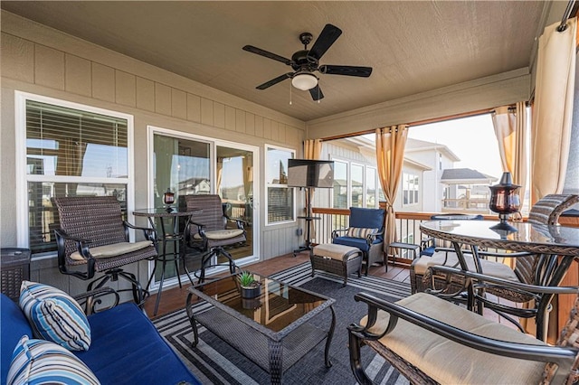 sunroom with a ceiling fan