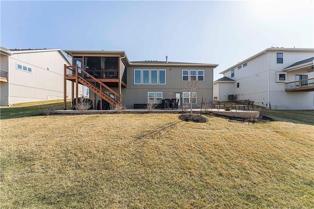 back of house with a patio area, stairway, a yard, and a sunroom