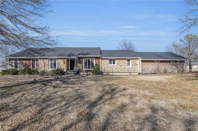 view of front of property featuring stone siding and a front yard